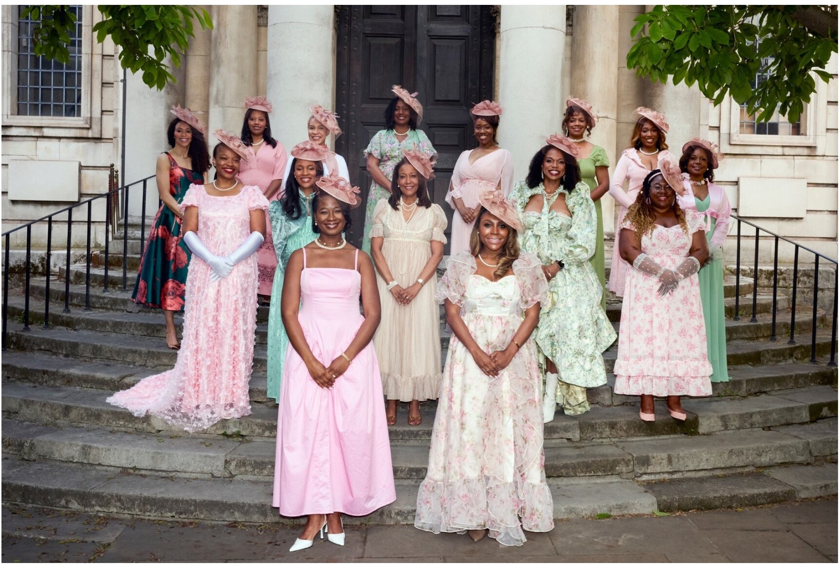 Sisters in pastel dresses on stone steps
